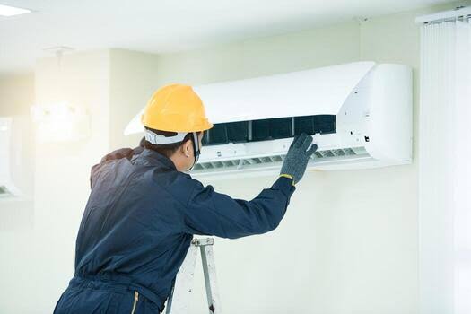 AC technician repairing an air conditioning unit