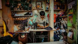 Tailor working on a sewing machine in a shop in India