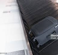 Small Black Luggage Bag On The Airport Baggage Claim Carousel Stock Photo -  Download Image Now