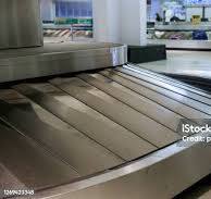 Rotating Black Rubber Airport Baggage Claim Carousel Conveyor Belt With A  Shiny Steel Body Frame Stock Photo - Download Image Now