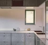 10 Kitchens with Color-Stained Wood Cabinets Instead of Paint