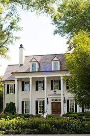 Black And White House With Wood Door Beautiful White House With Dormers Black Shutters And Grand Columns Framing The Wood Front Door Facade House My Dream Home Beautiful Homes