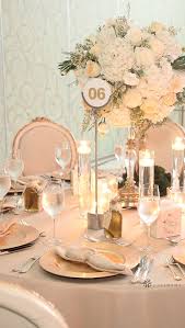 Classic Champagne And White Wedding With Large Floral Centerpieces And Silver Ute Champagne Wedding Themes Champagne Wedding Decorations Wedding Table Settings