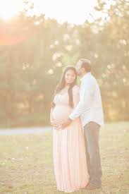 Birthday Gifts For Pregnant Wife From Husband In India Image Of A Pregnant Indian Woman And Her Husband Standing In A Park At Sunset While He Natural Light Maternity Maternity Photographer Maternity Photography