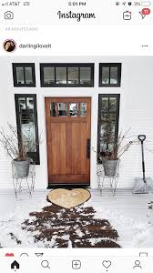 Black And White House With Wood Door Really Into White House Black Trim And Natural Wood Door White House Black Shutters White Exterior Houses House Designs Exterior