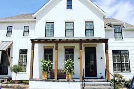 Black And White House With Wood Door White House Black Windows Modern Farmhouse Exterior House Exterior Farmhouse Exterior