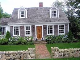 Landscaping With Hydrangeas And Low Shrubs As Well As A Beautiful Low Stone Wall This Is Classic And Hyd Cape Cod Exterior Cape Cod Style House House Exterior