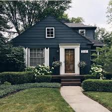 Black And White House With Wood Door Black Exterior Of House With White Shutters And Trim Natural Wood Door Mountain Home Exterior House Styles House Colors