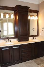 Double Vanity With Storage Tower Cabinet In The Middle And Towel Bathroom Vanity Designs Bathroom Mirror Cabinet Bathroom Remodel Master