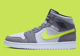 Nike Air Jordan 1 Mid Black Particle Grey White The Ubiquitous Air Jordan 1 Mid Appears In Grey And Volt Air Jordans Nike Air Best Sneakers