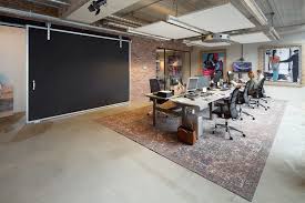 A Warehouse Is Transformed Into A Homey Office In Amsterdam Warehouse Office Office Space Design Warehouse Office Space