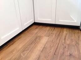 A Photo From Home Depot Reviewer Traffic Master Lakeshore Pecan With The White Cabinets Flooring Wood Laminate Flooring Laminate Flooring