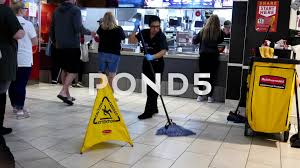 People Ordering Food And Worker Cleaning Floor At Mcdonalds Check Out Counter Stock Footage Worker Cleaning Food Peo Floor Cleaner Check Out Counter Mcdonalds