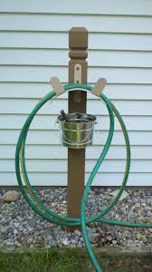 Simple Hose Holder Made From Post Bucket And Hose Rack From Home Depot Garden Hose Holder Garden Hose Hanger Hose Holder