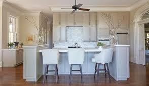 A Ceiling Fan Hangs Over A Gray Kitchen Island With End Cabinets Topped With White Marble Line Kitchen Cabinet Colors Grey Kitchen Island Grey Kitchen Cabinets