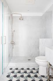 Black And Gray Triangle Pattern Floor Tiles Lead To A Seamless Glass Shower Fitted With Large Gray Marble Sur Patterned Floor Tiles Glass Shower Floor Patterns
