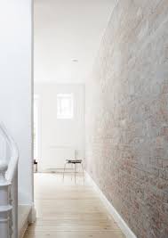 Hallway With White Washed Brick Wall From Upinteriors On Ello Brick Interior Brick Living Room White Wash Brick