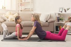 Young Woman And Child Daughter Doing Yoga Exercise At Home How To Do Yoga At Home Workouts Women Fitness Photography