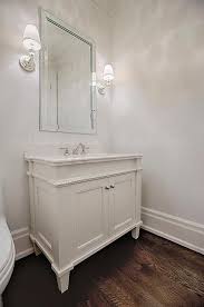 White Elegant Powder Room Features A White Footed Washstand Accented With Beading Topped With Whit Interior Design Projects Bathroom Design Wood Floor Bathroom