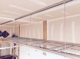 Garage Storage Rack Above Garage Door Made From Unit Strut And All Thread Rusedrack Garage Ceiling Storage Diy Garage Storage Garage Door Design