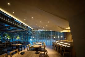 Once Lit At Night The Space S Colour Palette And Wooden Elements Emit A Sepia Like Ambience According T Architecture Minimalist Interior Mexico Restaurants