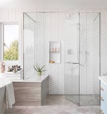 Walk In Shower With Floor To Ceiling White Herringbone Tile Glass Shower Doors Spa Like Bathroom Design Ba Bathroom Interior Design Home Bathroom Interior