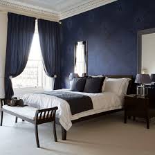The Striking Navy Wallpaper Behind The Bed Co Ordinates With The Stunning Curtains In This Elegant Bedr Blue Bedroom Walls Blue Master Bedroom Dramatic Bedroom