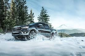A 2019 Ford Ranger Lariat Chrome Fx4 Supercrew Makes Its Way Along A Snow Covered Road A Snow Covered Mountain Is Visible Ford Ranger 2019 Ford Ranger Ranger