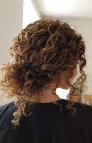 We love the asymmetry of this style. Untamed Tresses Naturally Curly Wedding Hairstyles