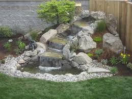 Adorable Waterfall Ideas For Backyard Corner Beside Wooden Fence Including Green Grass Water Features In The Garden Waterfalls Backyard Backyard Water Feature