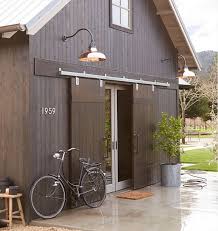 Copper Barn Lights Barn Style Home With Exterior Barn Doors And Copper Barn Lights Lighting Is Rejuvenati Exterior Barn Doors Barn Style House House Exterior