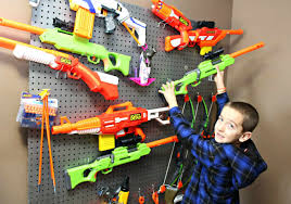 Space out 2 pegs at approximately the same length as hang a wire rack on your wall using screws, anchors, or other attachments depending on the wall material. How To Build A Nerf Gun Wall With Easy To Follow Instructions