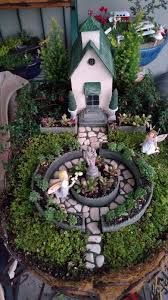 Miniature Fairy Garden In Awe Two Girl Fairies Who Are In Awe Of The Blessed Mother And Baby Statue Fairy Garden Miniature Fairy Gardens Fairy Garden Houses