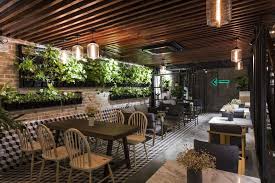Nature Infused Industrial Cafe Interiors Industrial Cafe Interior Cafe Design Garden Cafe House Design