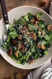 Tahini Kale Caesar Salad With Whole Grain Croutons Naturally Recipe Kale Caesar Salad Caesar Salad Caesar Salad Bites