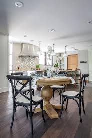 Black X Back Dining Chairs Accented With Gray Seats Surround A Light Stained Round P Round Pedestal Dining Round Pedestal Dining Table Transitional Dining Room