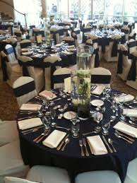 Our Ivory Tablecloth Under Our Satin Navy Overlays With Ivory Chair Covers And Satin Navy Chair Sash Navy Tablecloths Wedding Wedding Table Wedding Decorations