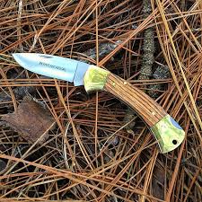 Nylon checkered handle on lays with light weight grip. Gerber Winchester Zebra Wood Pocket Knife 31 002655 Gold Bolsters