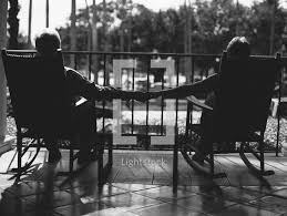 Couple In Rocking Chairs Holding Hands On A Porch Rocking Chair Chair Married Couple