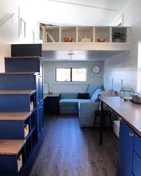 The Living Room Has A Built In Entertainment Center And L Shaped Couch Storage Stairs Provide Several Stor Modern Tiny House Best Tiny House Tiny House Living