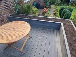 Composite Deck Is Made From The Combination Of Wood Plastics And Small Amount Of Bonding Agents And It Is A Man M Deck Planters Deck Garden Back Garden Design