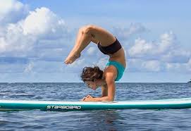 12 Amazing Paddleboard Yoga Poses And How To Do Them Livestrong Com Paddle Board Yoga Yoga Poses Photography Paddle Boarding
