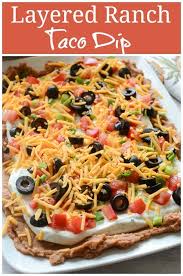 Layered Ranch Taco Dip Layers Of Refried Beans Sour Cream With Ranch Tomato Olives Cheese And More N In 2020 Delicious Dips Recipes Yummy Dips Layered Taco Dip