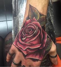 This simple rose tattoo is of a black and white color. Tattoo Hand Rose Hand Tattoos For Guys Rose Hand Tattoo Hand Tattoos