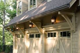 Carriage Door Style Works Well With The Decorative Brackets Under Eaves And Gorgeous New Lighting See M Garage Door Styles Garage Door Design House With Porch