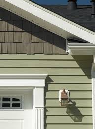 Plank Vinyl With Wood Shingle Style Accent White Trim And Decorative Vinyl Garage Door Wrapping Frame Green Siding Siding Options House Siding Options