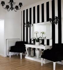A Black And White Entrance Hall Features A Bold Striped Wall That Allows The Furniture And Accessories To Pop Vertical Stripes White Interior White Decor Home
