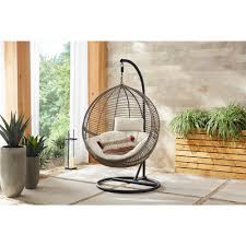 Hampton Bay Brown Wicker Round Outdoor Patio Egg Lounge Chair Swing With Biscuit Tan Cushions 65 18246a The Home Depot Patio Swing Patio Swing Chair Outdoor Patio Swing