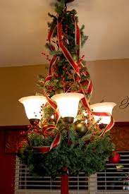 Use A Plain Wreath Upside Down Bend The Branches To Attach To The Light Wrap A Matching Garland Aro Christmas Chandelier Christmas Decorations Christmas Deco