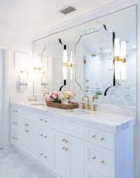 Art Deco Mirrors Are Mounted To A Frameless Vanity Mirror Hung Over A White Dual Wa Art Deco Bathroom Vanity Decorative Bathroom Mirrors White Marble Bathrooms